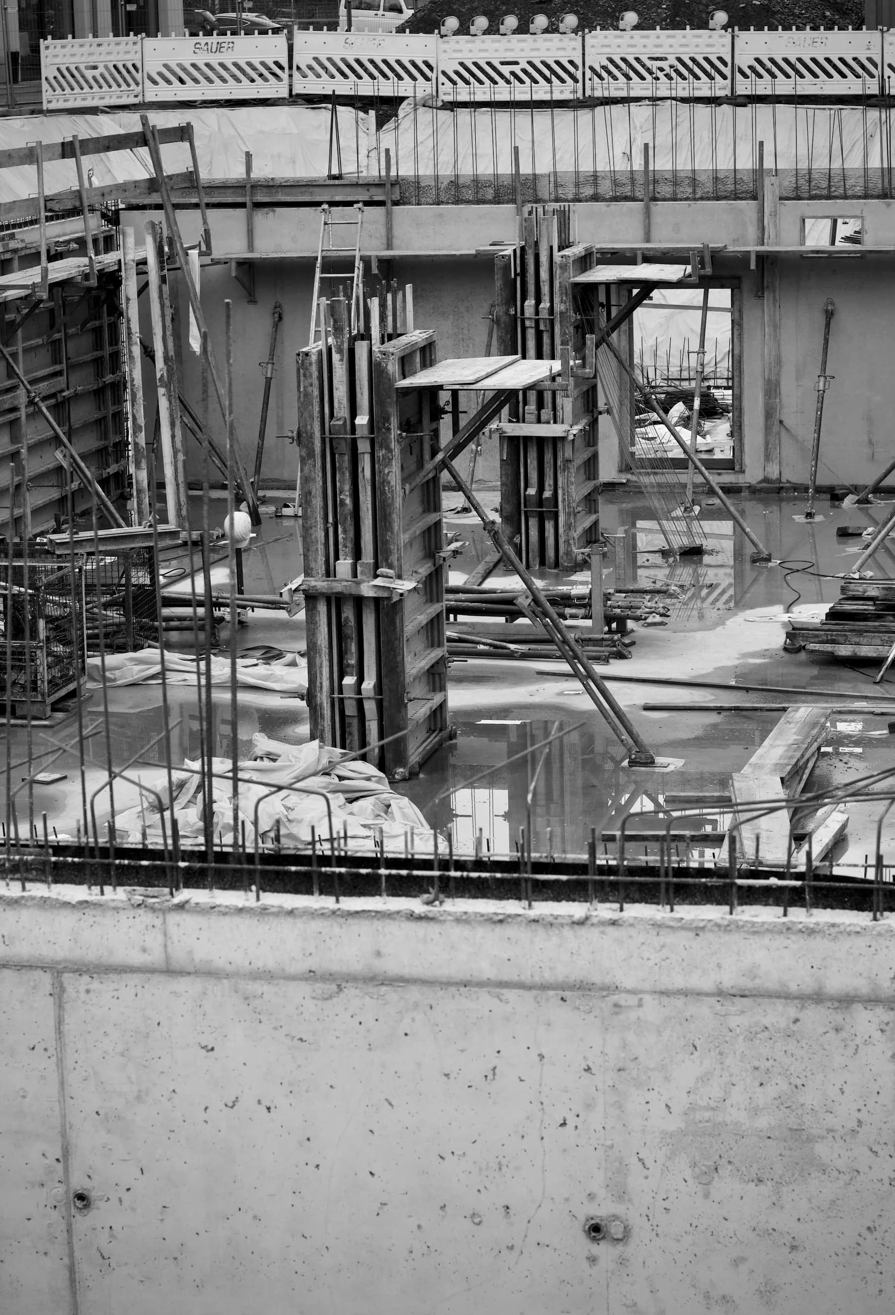 Black-and-white construction site with a steel framework