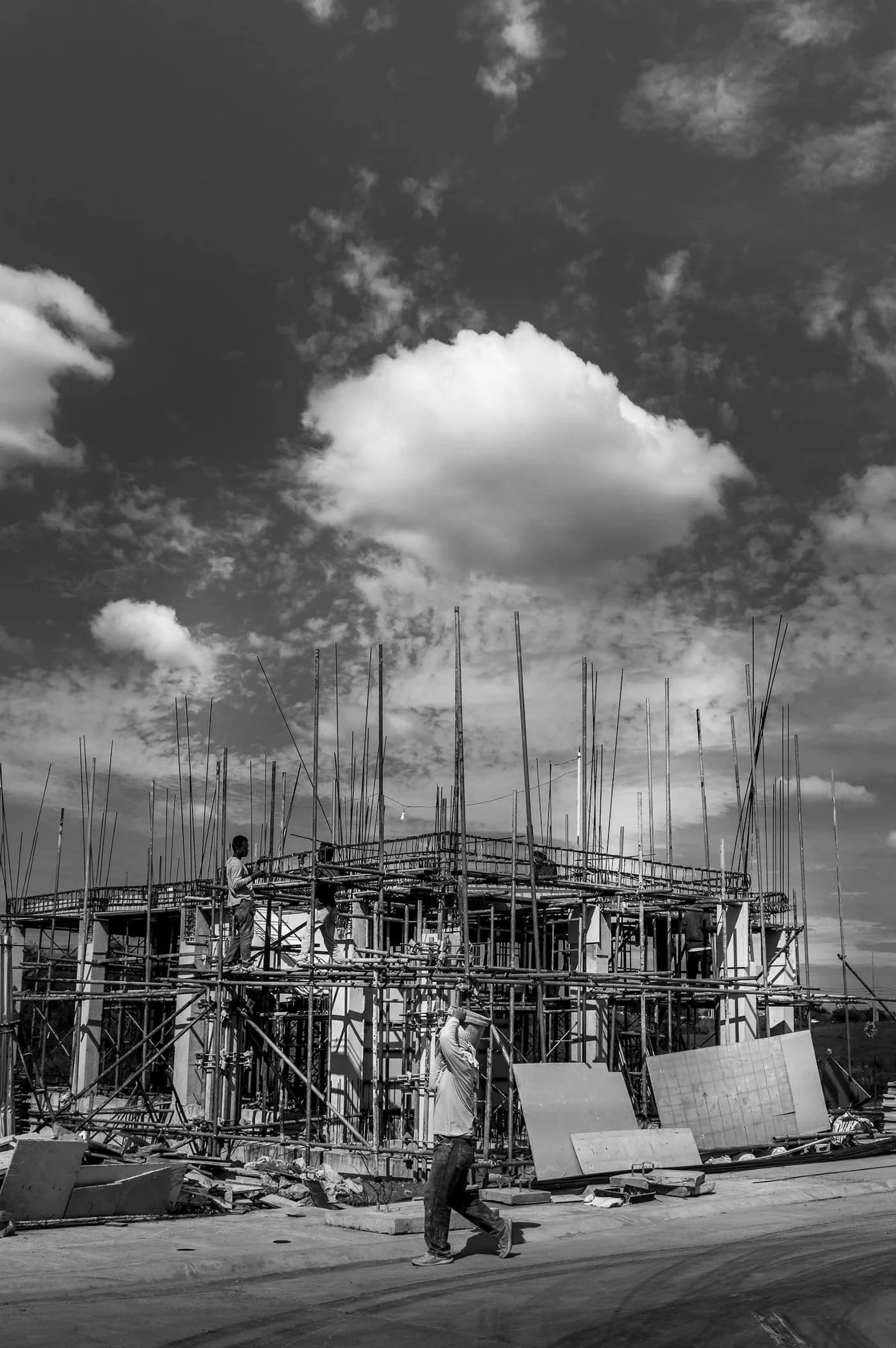 Black-and-white construction site with a worker