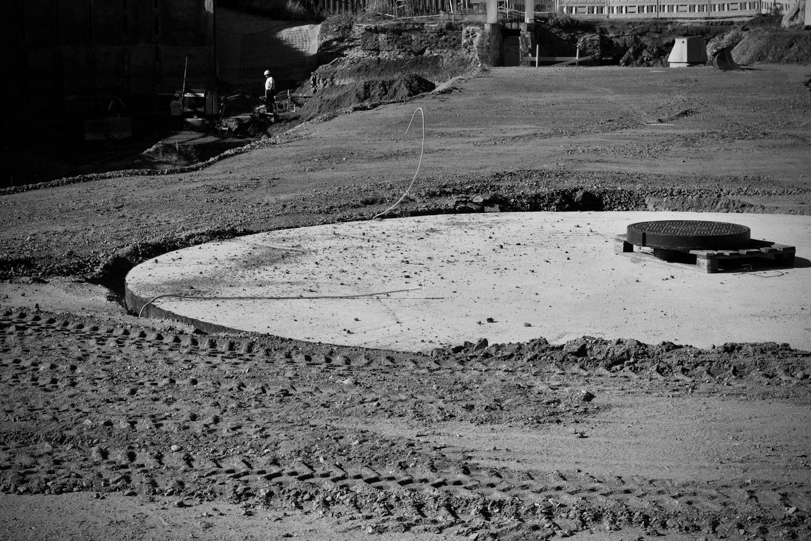 Black-and-white construction site with worker